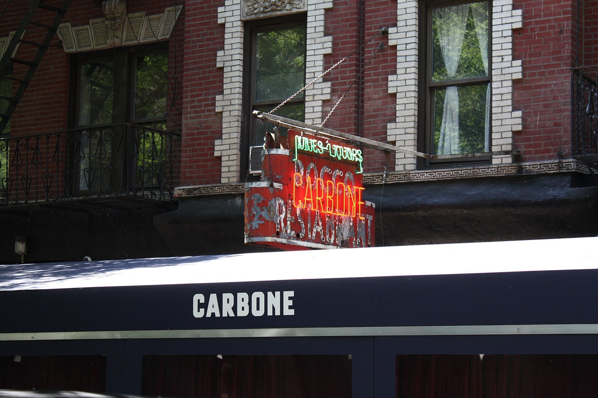 Photo of the sign and the top of the outdoor dining structure of the restaurant Carbone in New York City (Carbone (restaurant))